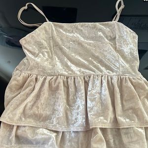A cream colored babydoll top.